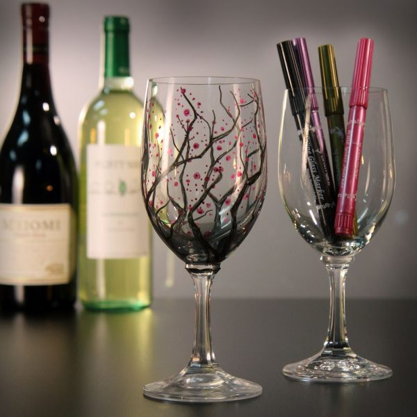 wine glasses written on with Drimark markers with bottles of wine in the background glam photo